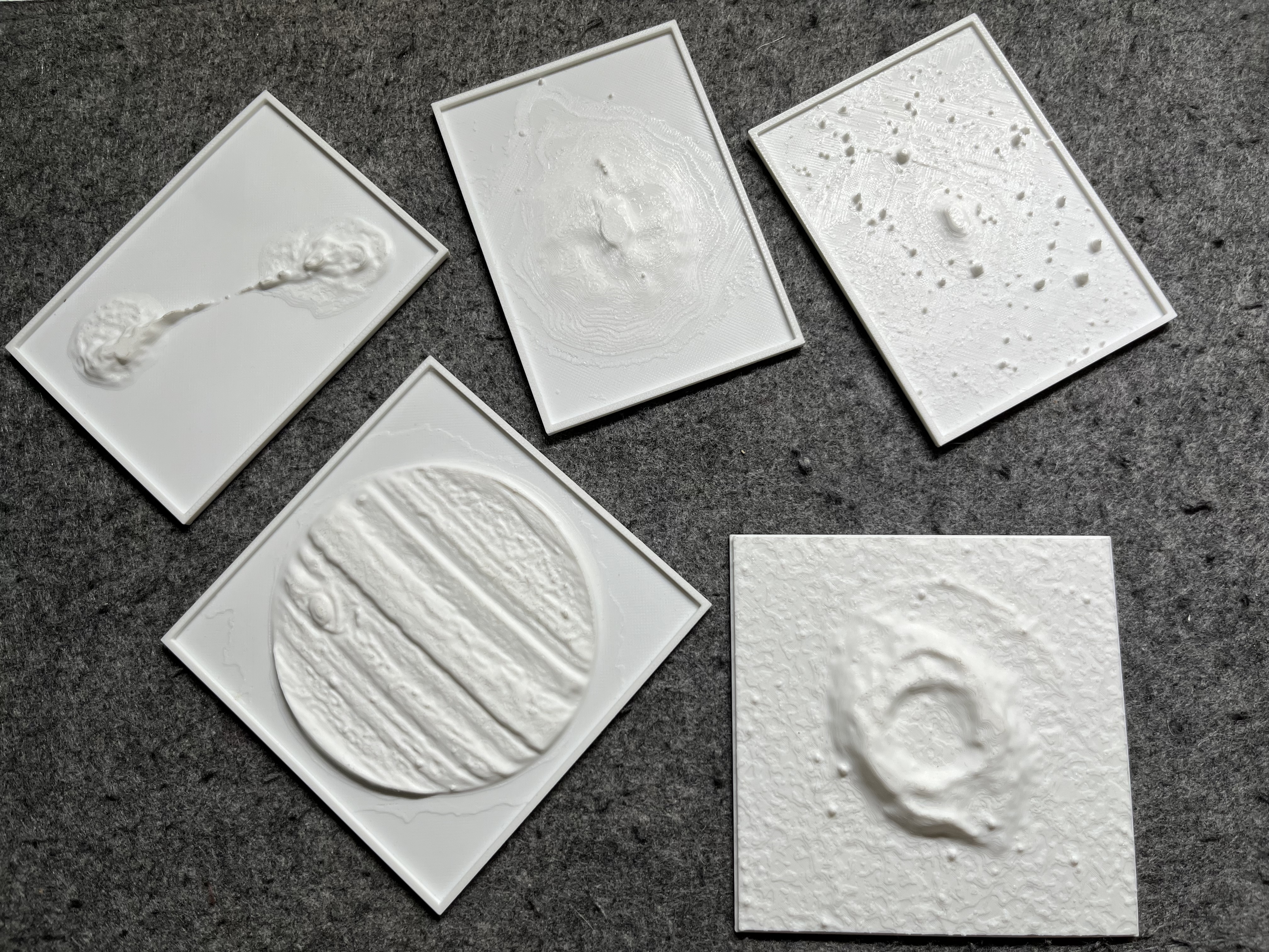 Several 3D printed models of astronomical objects